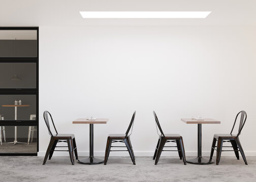 Blank wall inside a coffee shop with tables and chairs
